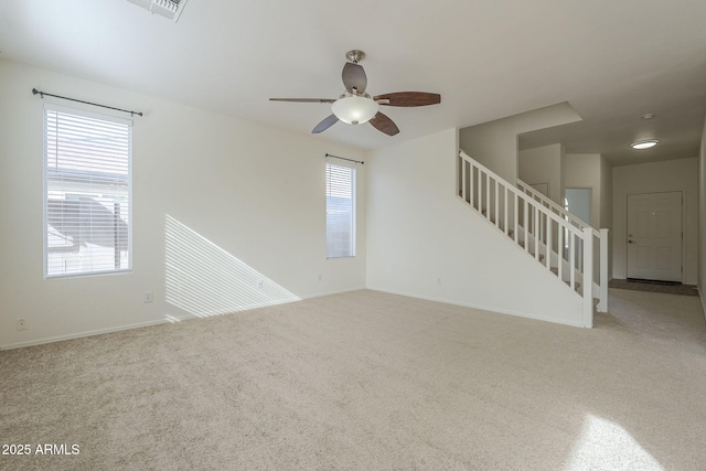 unfurnished living room featuring carpet floors and ceiling fan