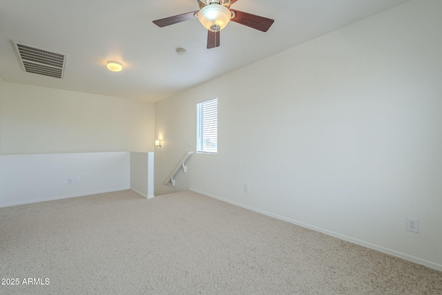 spare room with baseboards, visible vents, and carpet flooring