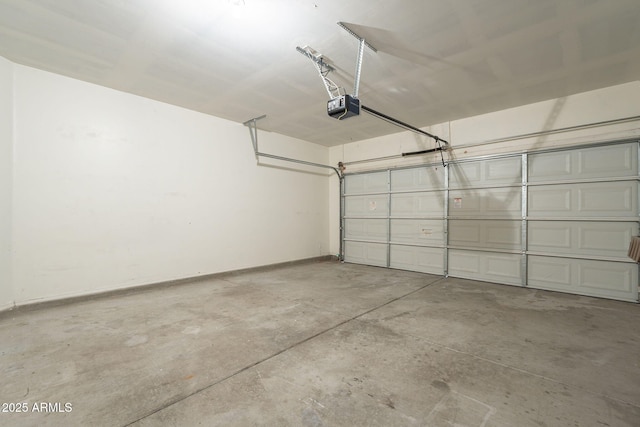 garage with a garage door opener and baseboards