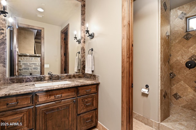 bathroom featuring vanity and a tile shower
