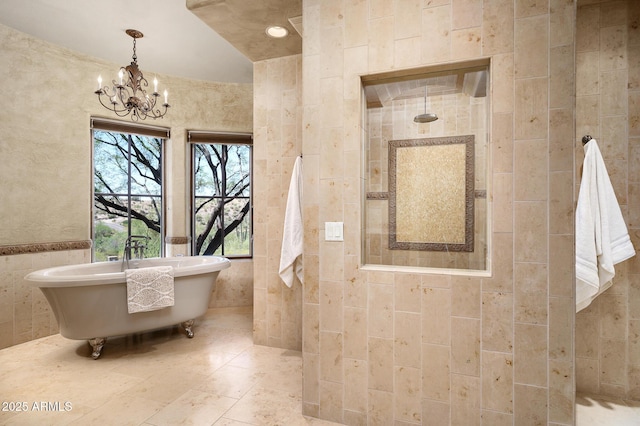 full bath featuring a tile shower, tile walls, a notable chandelier, and a soaking tub