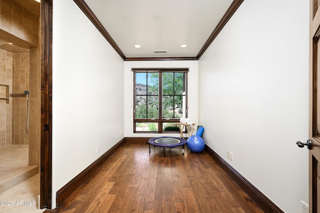 unfurnished room with wood finished floors, visible vents, recessed lighting, crown molding, and baseboards