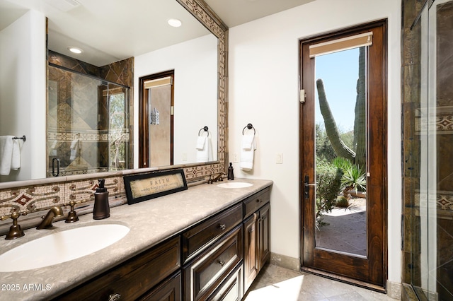bathroom with a sink, double vanity, backsplash, and a shower stall