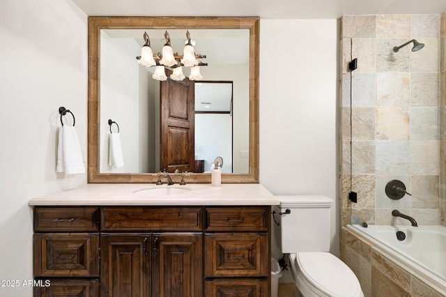 full bath with toilet, a notable chandelier, tiled shower / bath combo, and vanity