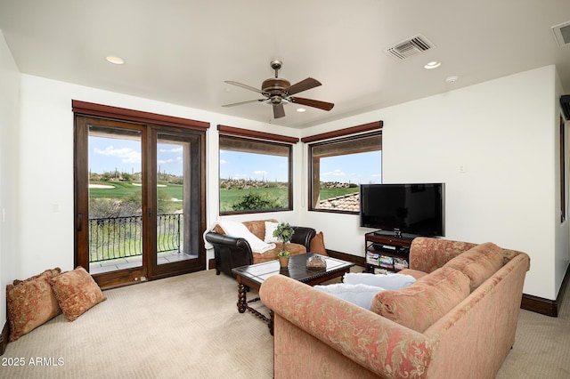 living area featuring a ceiling fan, recessed lighting, visible vents, and light colored carpet