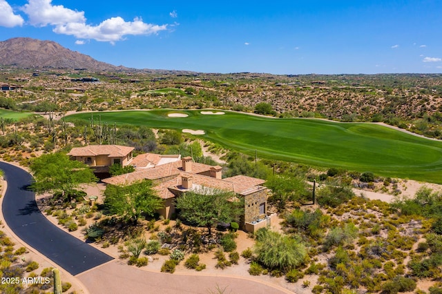 birds eye view of property featuring view of golf course and a mountain view