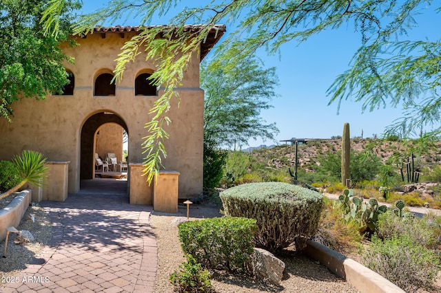 entrance to property featuring stucco siding