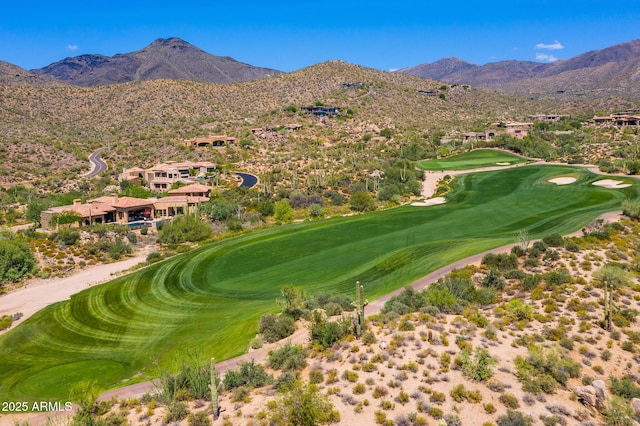 view of property's community with view of golf course and a mountain view