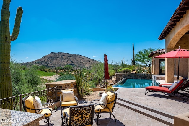 view of pool with a mountain view, a patio, and a fenced in pool