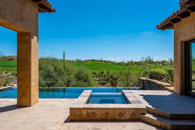 pool featuring an in ground hot tub, a patio, and golf course view
