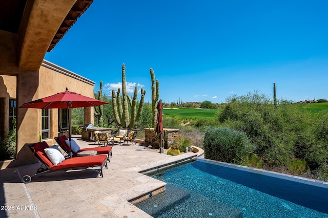 outdoor pool featuring a patio and view of golf course