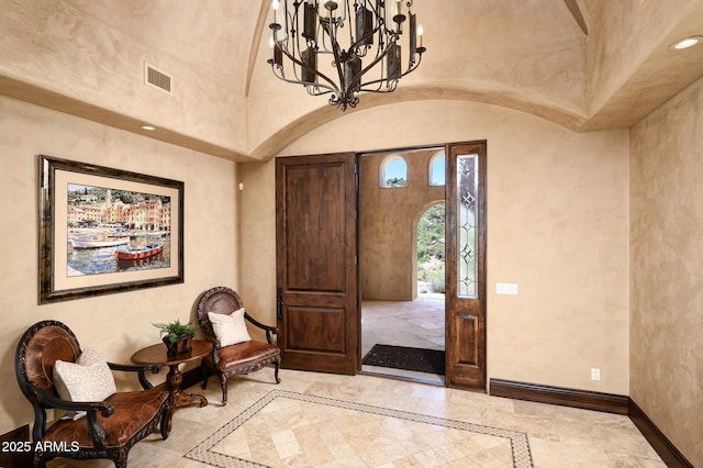 entryway featuring an inviting chandelier, visible vents, baseboards, a towering ceiling, and recessed lighting