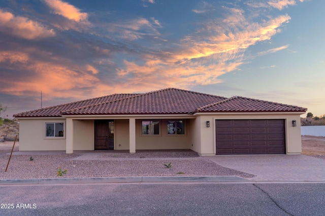 115 Ironwood Pl, Wickenburg, AZ 85390 - mediterranean / spanish-style home with a garage, a tile roof, stucco siding, and decorative driveway