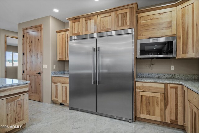115 Ironwood Pl, Wickenburg, AZ 85390 - kitchen with light brown cabinetry, light stone counters, recessed lighting, and appliances with stainless steel finishes