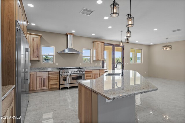 115 Ironwood Pl, Wickenburg, AZ 85390 - kitchen with wall chimney exhaust hood, visible vents, a sink, and high quality appliances