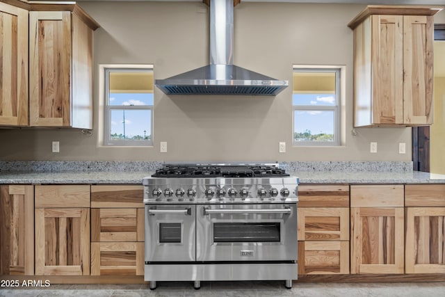 115 Ironwood Pl, Wickenburg, AZ 85390 - kitchen featuring wall chimney exhaust hood, high end stainless steel range oven, light brown cabinets, and a wealth of natural light