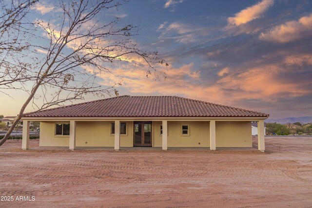 115 Ironwood Pl, Wickenburg, AZ 85390 - back of property with stucco siding, a tile roof, and french doors
