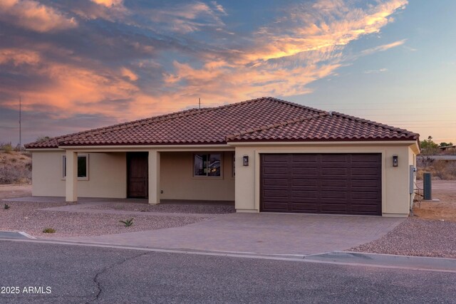 115 Ironwood Pl, Wickenburg, AZ 85390 - mediterranean / spanish-style home with stucco siding, a tile roof, a porch, and an attached garage