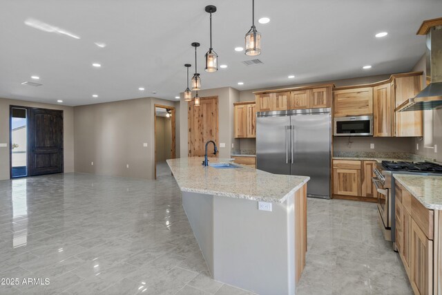 115 Ironwood Pl, Wickenburg, AZ 85390 - kitchen with wall chimney range hood, recessed lighting, premium appliances, and a sink