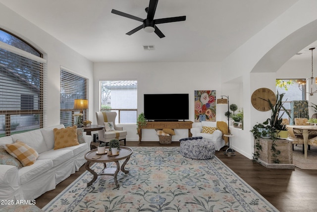 23705 S Pleasant Way, Sun Lakes, AZ 85248 - living room with visible vents, wood finished floors, baseboards, arched walkways, and ceiling fan with notable chandelier