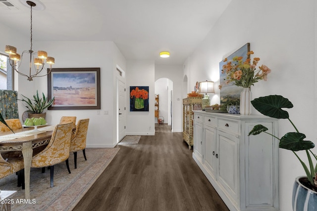 23705 S Pleasant Way, Sun Lakes, AZ 85248 - dining space featuring visible vents, arched walkways, baseboards, dark wood-style floors, and an inviting chandelier