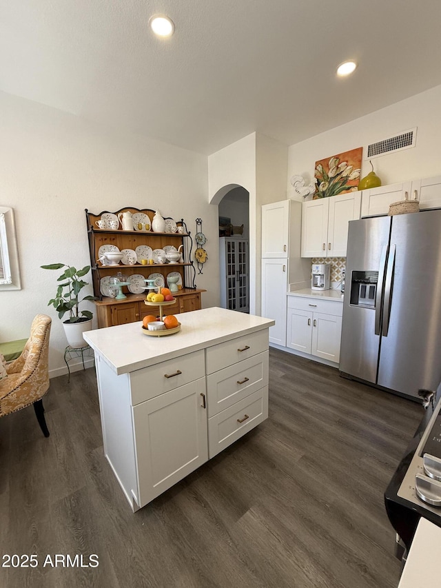 23705 S Pleasant Way, Sun Lakes, AZ 85248 - kitchen featuring stainless steel fridge with ice dispenser, light countertops, arched walkways, visible vents, and dark wood-style floors