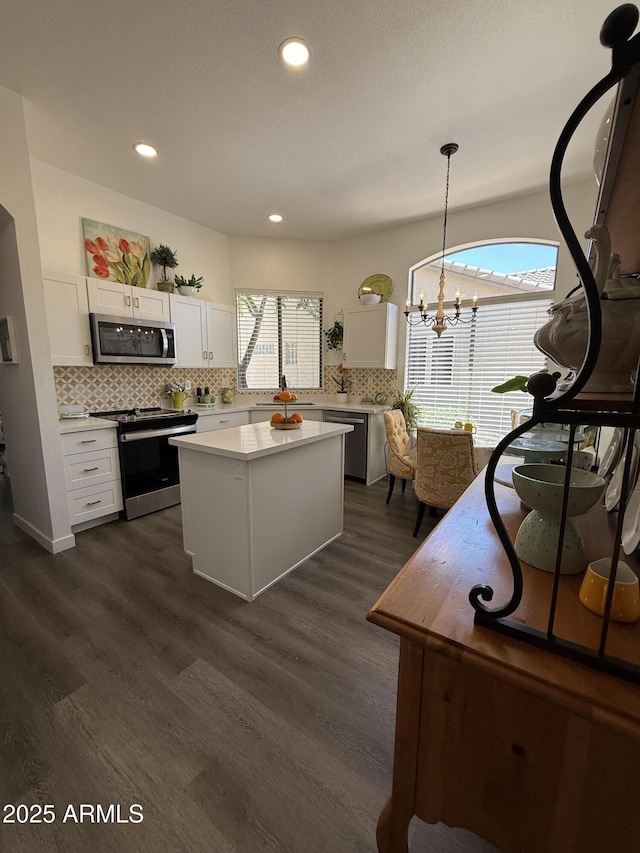 23705 S Pleasant Way, Sun Lakes, AZ 85248 - kitchen with white cabinets, light countertops, a center island, stainless steel appliances, and backsplash