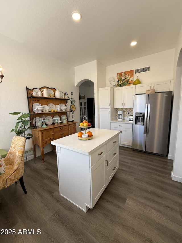 23705 S Pleasant Way, Sun Lakes, AZ 85248 - kitchen with dark wood-style flooring, light countertops, arched walkways, stainless steel refrigerator with ice dispenser, and visible vents