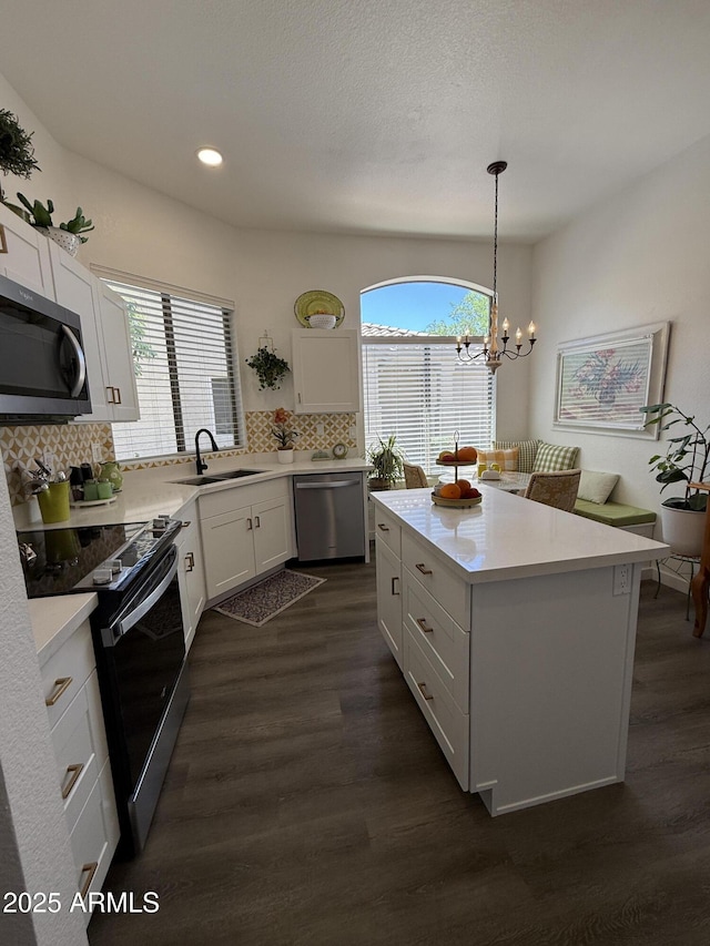 23705 S Pleasant Way, Sun Lakes, AZ 85248 - kitchen featuring dark wood-style flooring, appliances with stainless steel finishes, tasteful backsplash, a sink, and white cabinets