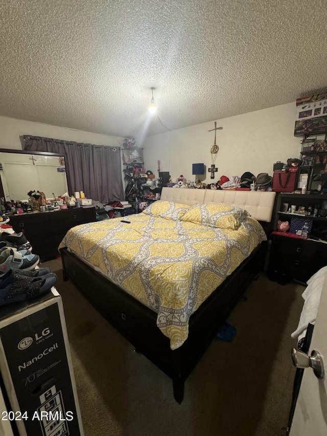 bedroom featuring a textured ceiling and carpet flooring