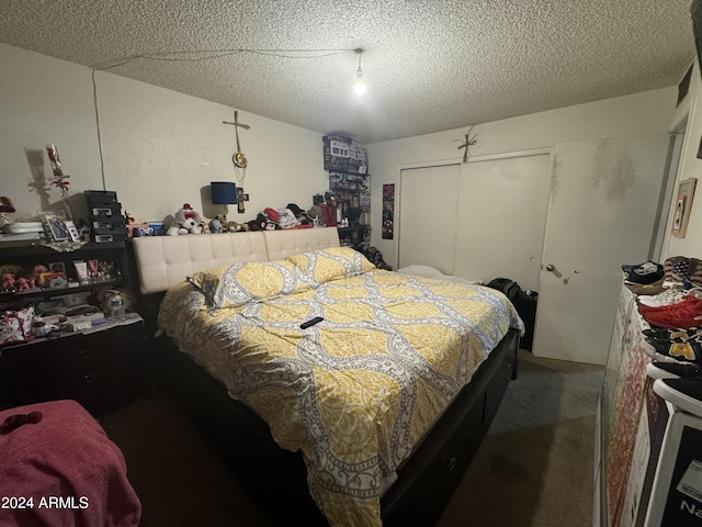 carpeted bedroom featuring a textured ceiling and a closet