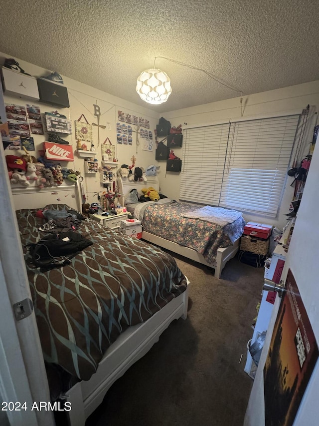 carpeted bedroom featuring a textured ceiling