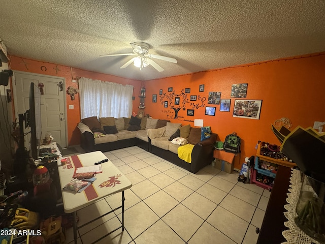 living room with a textured ceiling, ceiling fan, and light tile patterned floors