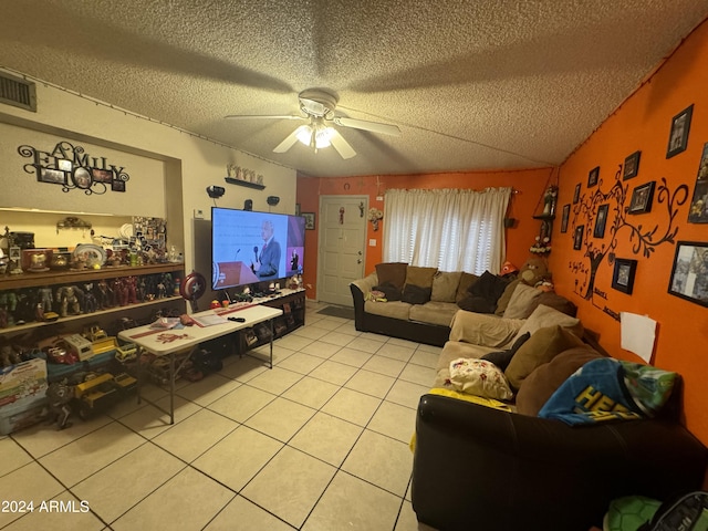 tiled living room with ceiling fan, vaulted ceiling, and a textured ceiling