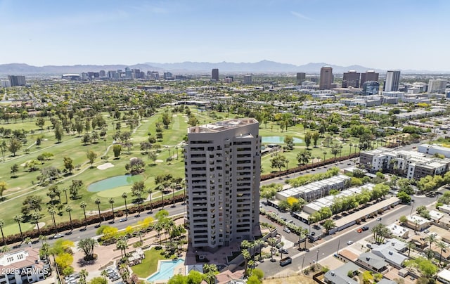 drone / aerial view featuring a city view, a water and mountain view, and view of golf course