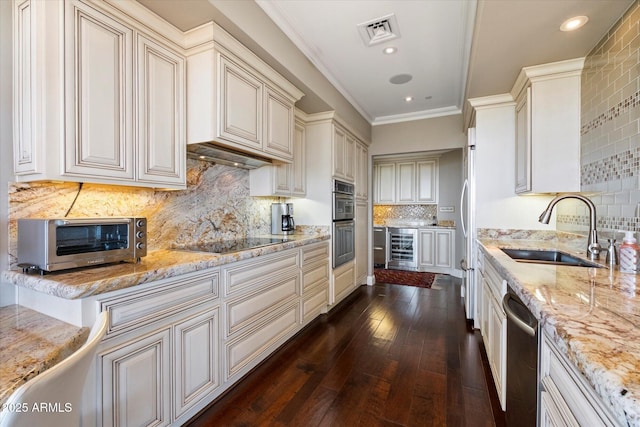 kitchen with visible vents, light stone countertops, wine cooler, appliances with stainless steel finishes, and a sink