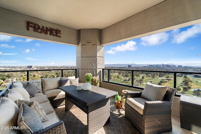 balcony featuring an outdoor living space, visible vents, and a city view