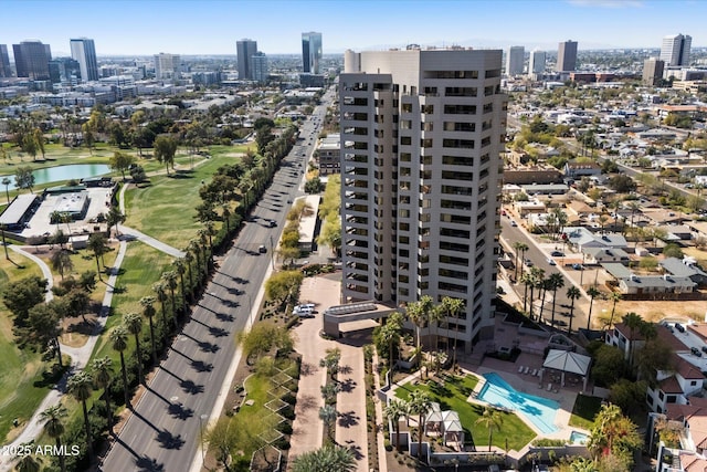 birds eye view of property with a water view and a view of city