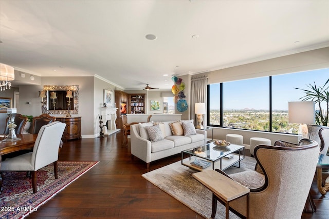 living area featuring baseboards, wood-type flooring, crown molding, and ceiling fan with notable chandelier