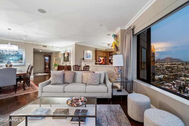 living area with ornamental molding, baseboards, and wood finished floors