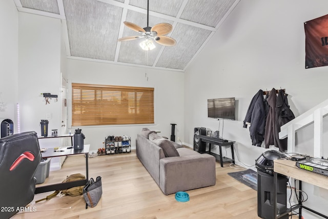 living room featuring high vaulted ceiling, light wood-style flooring, and a ceiling fan