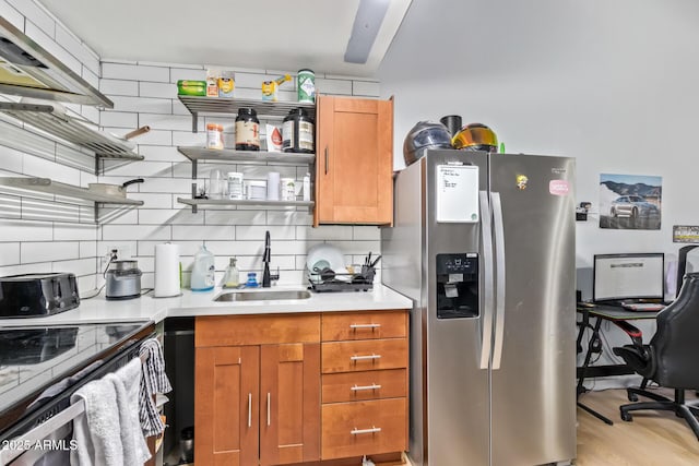 kitchen featuring light countertops, open shelves, stainless steel refrigerator with ice dispenser, and a sink