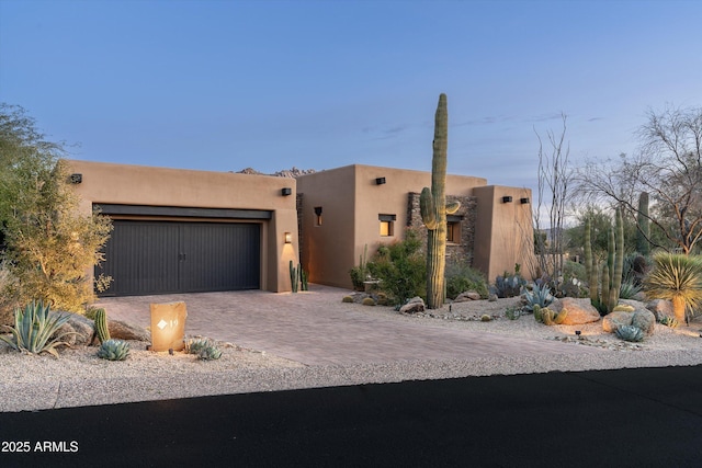 pueblo-style home with a garage