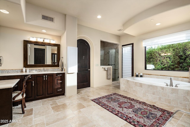 bathroom featuring vanity and separate shower and tub