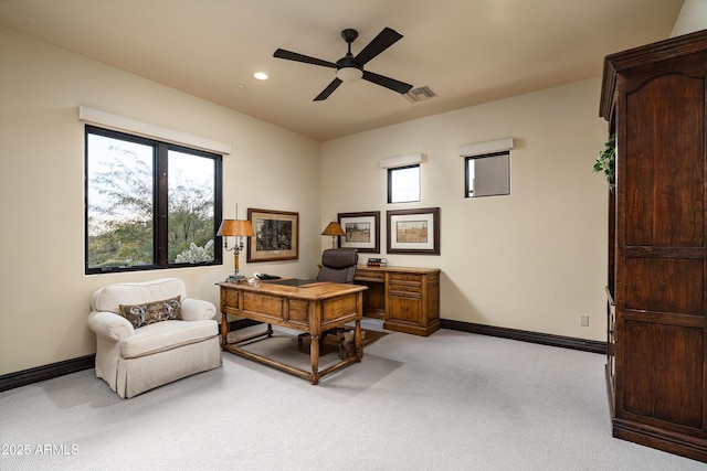 office space with ceiling fan and light carpet