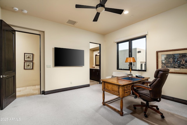 office area featuring light carpet and ceiling fan