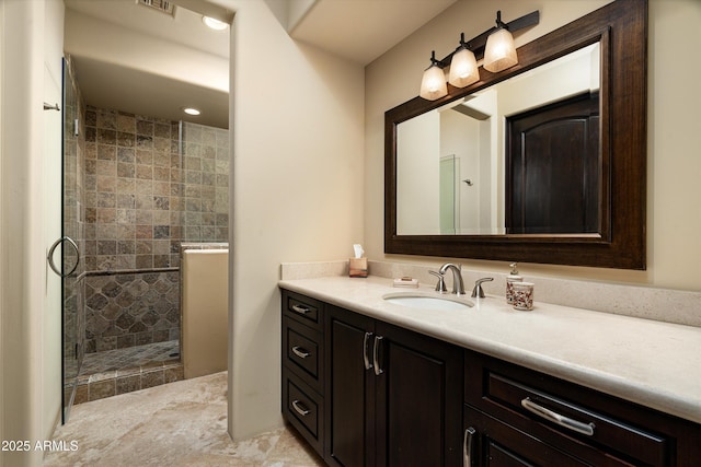 bathroom with vanity and a shower with shower door