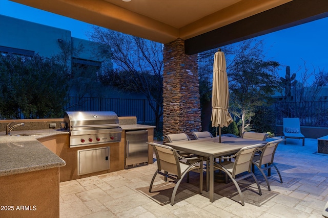 view of patio / terrace featuring a grill, exterior kitchen, and sink