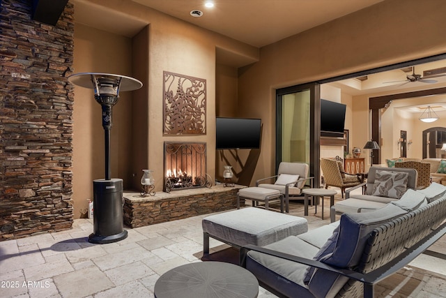 view of patio with an outdoor living space with a fireplace