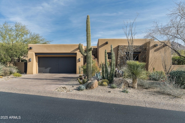 adobe home featuring a garage